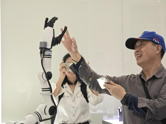 参观者与具身智能机器人手臂进行互动。人民网记者 焦磊摄